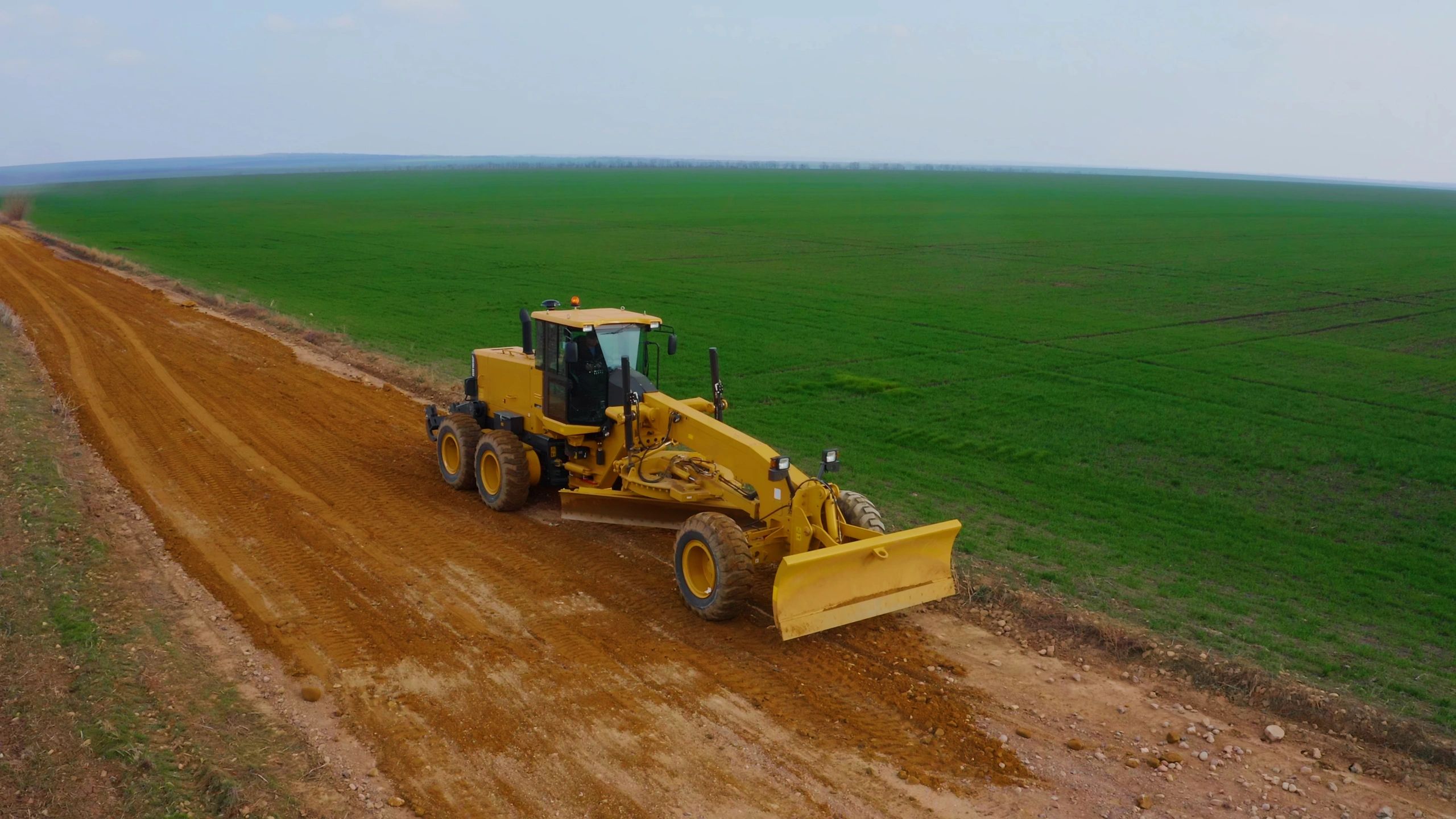 Heavy equipment working on a dirt road construction site