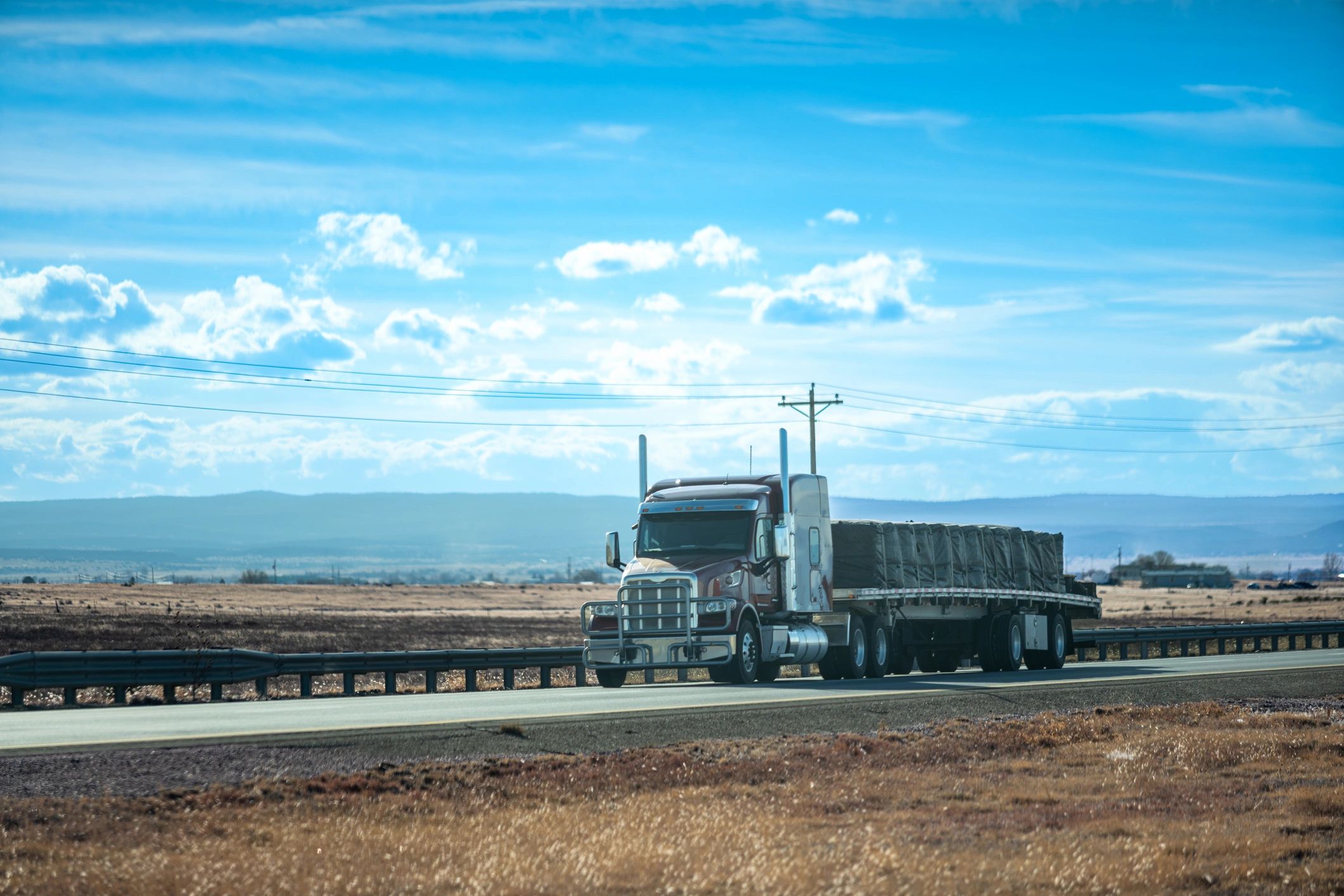 Flatbed truck transporting cargo for long-distance hauling