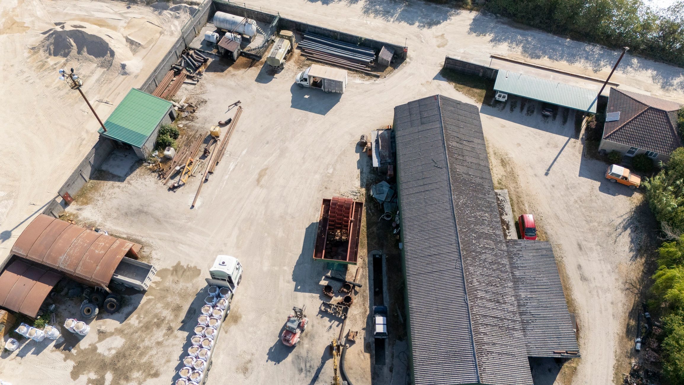 Industrial materials yard with trucks and stockpiles
